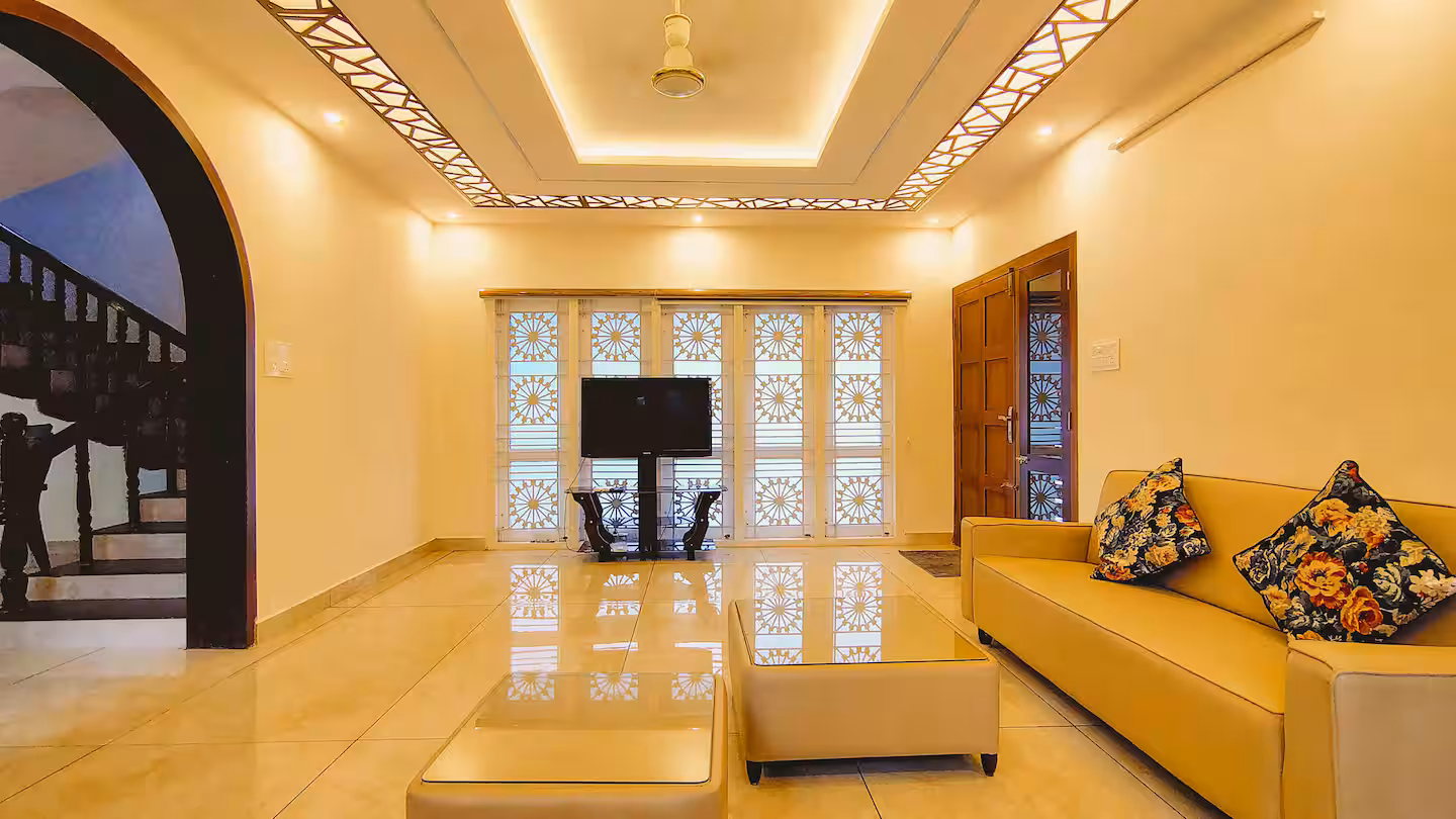 Spacious ground floor living room with plush sofas at Riverside Retreat villa